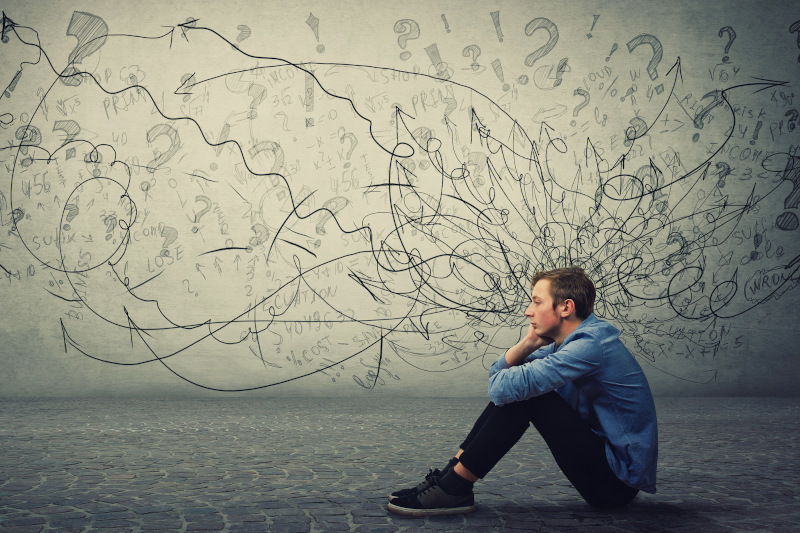 Upset and tired boy teenager sitting on the floor keeps hand to cheek looking thoughtfully and hopeless. Stressed student guy feels emotional discomfort, anxiety and mental health problems. Test Therapist