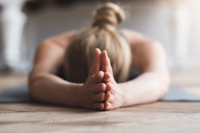 Woman laying face down on yoga mat, meditating Teenage Depression Therapist in Collingwood, Ontario