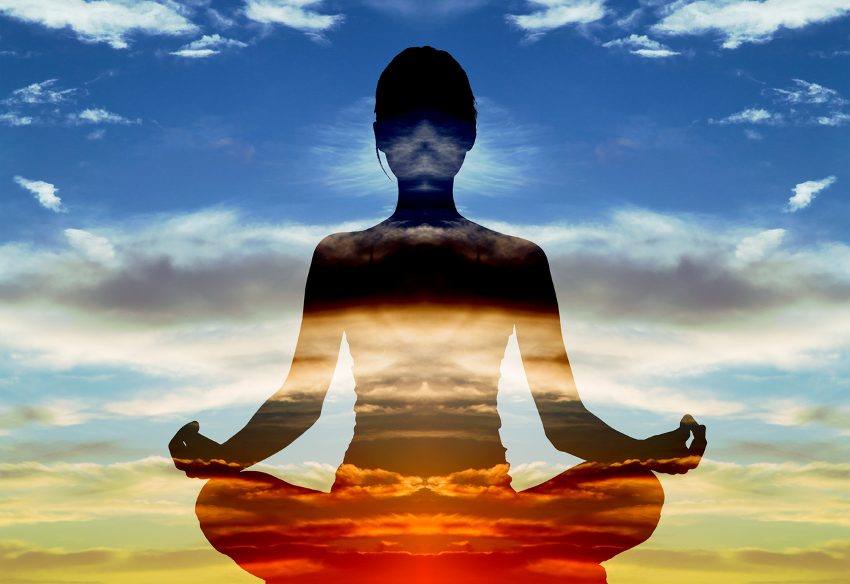 Silhouette of woman doing yoga in lotus position over sunset sky. Concept of connection with the universe and nature. The Importance of Cultivating the Use of Self