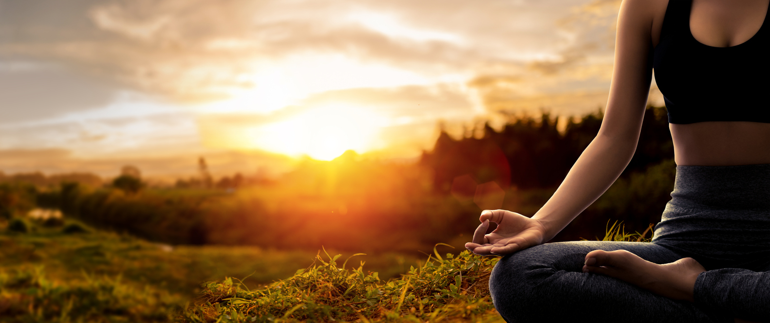 Young woman practicing yoga in sunset time iStock-1307266333